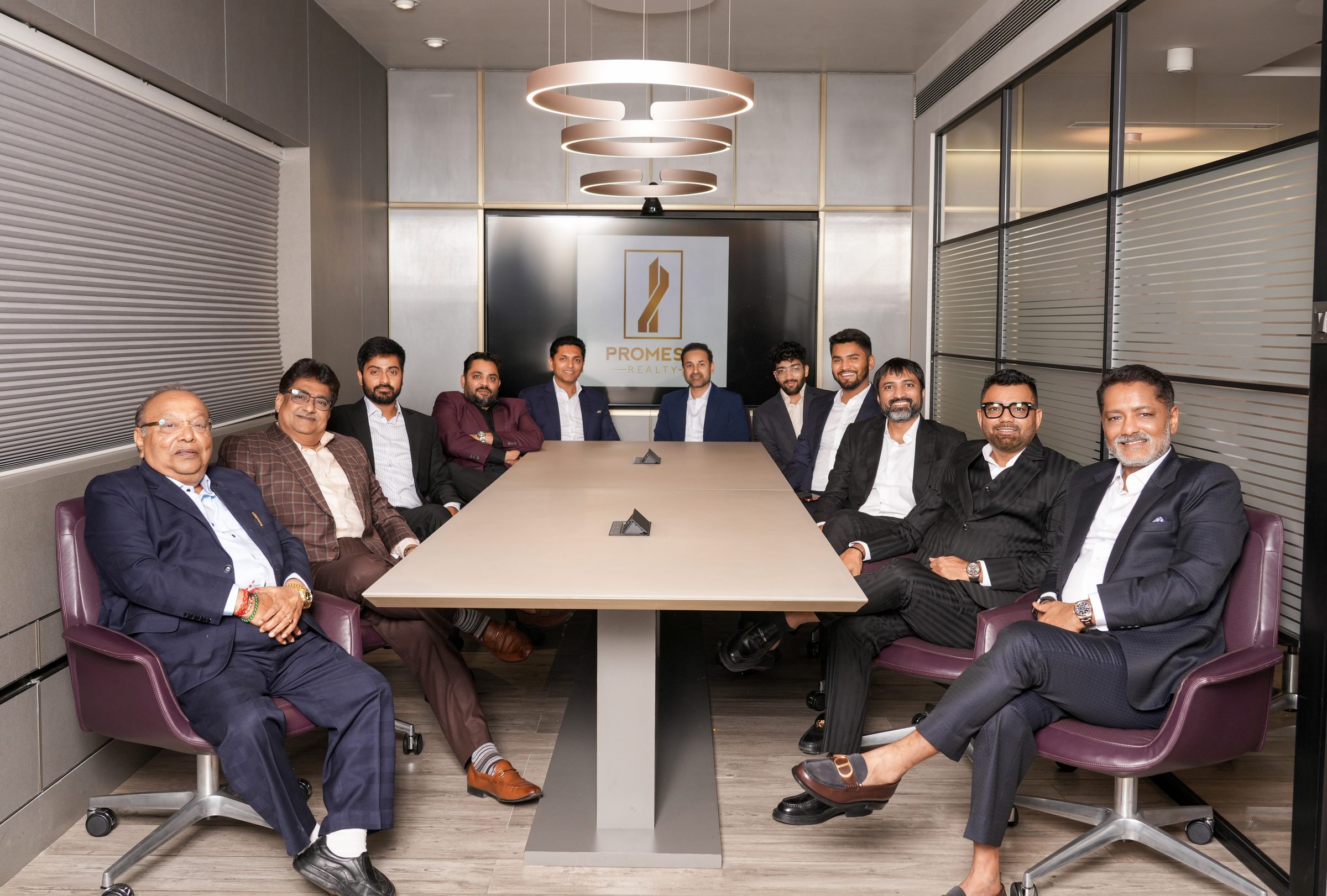 The Promesa Realty leadership team gathered around the boardroom table at the company office